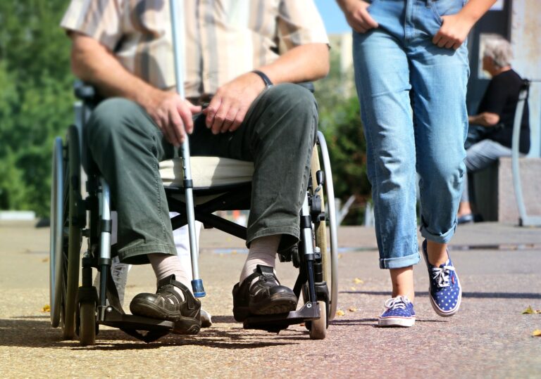 Senior in wheelchair with young adult